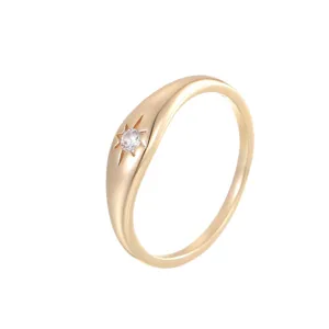 Gold plated sterling silver ring featuring a sparkling starburst cubic zirconia center stone.
