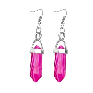 Close-up details of vibrant pink hexagonal crystal bullet earrings with shiny silver hooks.