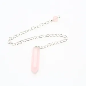 Pink crystal hexagonal prism pendulum pendant detail view, silver chain accessory.