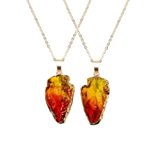Arrowhead crystal pendant necklace with vibrant gradient color rough stone on fine gold chain.