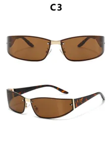 Detail view of Y2K retro sunglasses with brown lenses, gold metal bridge and tortoise temples.