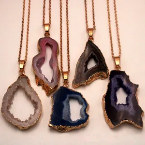 Natural agate geode pendant necklace detail showing crystal cluster and electroplated edges.