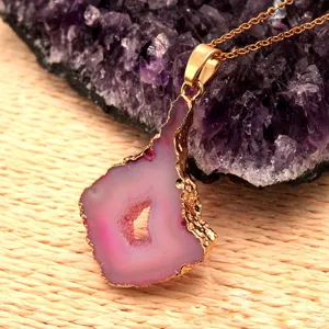 Natural pink agate geode slice pendant necklace with gold plated bezel for women detail view.