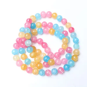 Primo piano di perline di vetro crepato colorate, perle rotonde per creazione di gioielli.