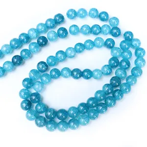 Close-up detail of blue crackle agate gemstone beads strand, smooth surface polished round.