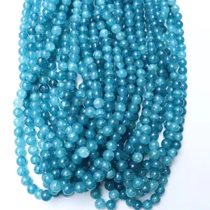 Close-up detail of blue cracked agate gemstone beads strands, vibrant color texture for jewelry.