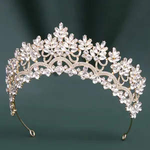 Close-up detail of luxury gold bridal tiara sparkling marquise crystal stones wedding hair piece.