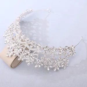 Close-up of sparkling silver crystal bridal tiara showing intricate rhinestone details.