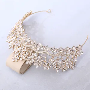Stunning gold crystal bridal tiara detail, marquise rhinestone crown close up display.