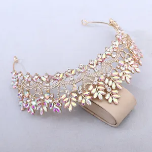 Close-up detail of luxury gold crystal tiara with sparkling rhinestones for bridal weddings.