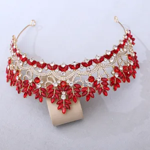 Detailed close-up shot of sparkling red crystal bridal tiara crown with gold alloy base.