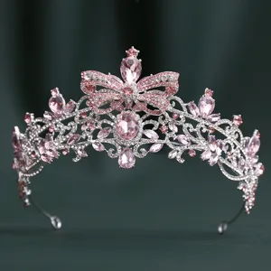 Detailed close-up of the sparkling Baroque rhinestone bridal crown featuring pink crystal bow design.