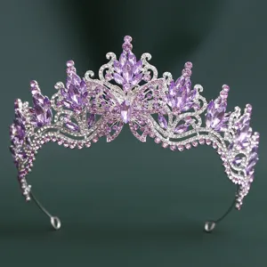 Close-up detail of a stunning purple crystal baroque tiara crown with delicate butterfly wings.