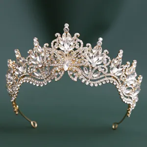 Close-up detail of luxury gold rhinestone crystal bridal tiara sparkling baroque hair crown.