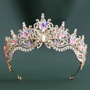 Detailed close-up of luxurious gold baroque tiara encrusted with colorful crystal rhinestones.