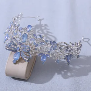 Detailed close-up of a stunning blue rhinestone bridal tiara featuring elegant butterfly motifs.