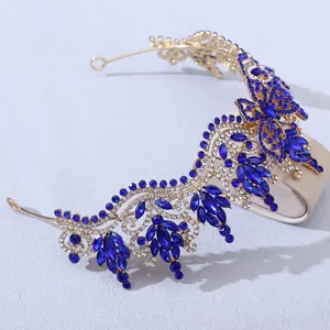 Stunning gold crystal bridal tiara detail view, blue rhinestone butterfly hair crown accessory.