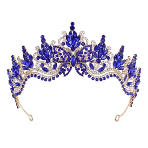 Detail shot of baroque blue crystal rhinestone tiara, intricate butterfly metal crown design.