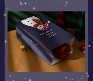 Bolsa de regalo de papel navideño para manzanas y obsequios, diseño de muñeco de nieve azul.