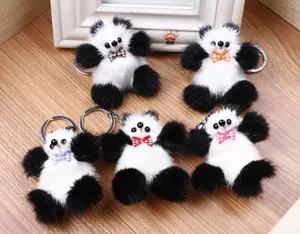 Detalle de llavero panda esponjoso con pelaje suave y un bonito lazo a cuadros.