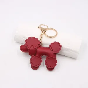 Red leather poodle keychain pendant, cute puppy bag charm with gold metal hardware ring.