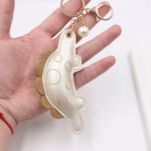 Cute gold dinosaur keychain pendant with stylish pearl charm for bags and keys gift