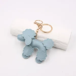 Cute light blue leather poodle keychain and bag charm with gold tone hardware and keyring pendant.
