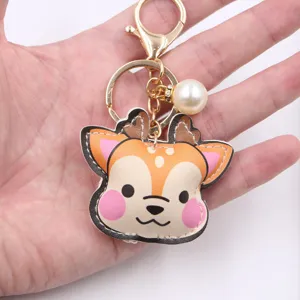 Cute deer leather keychain with pearl pendant, soft stuffed cartoon fawn bag charm accessory.