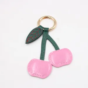 Schattige kersen lederen sleutelhanger tas charm, stijlvolle vrouwen auto sleutelring accessoire.
