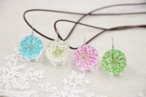 Handcrafted dried flower glass ball necklace detail, fresh style floral resin pendant.