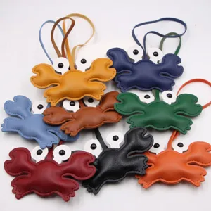 Leather crab bag charm keyring detail shot, multi-color cute accessory with strap pendant.