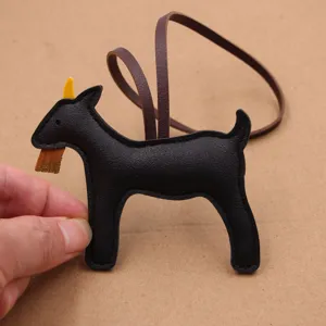 Black leather goat bag charm with strap, cute animal pendant accessory for handbag.