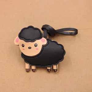 Cute black sheep leather bag charm pendant detailed view, handmade DIY clothing accessory.