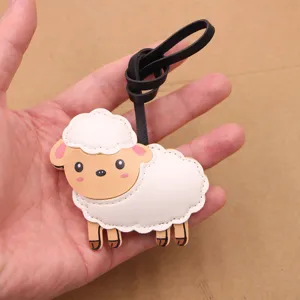 Close-up view of a cute sheep leather bag charm pendant showing detailed texture and strap design.