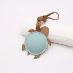 Cute leather sea turtle bag charm, stylish brown and light blue handbag pendant accessory.