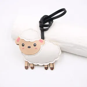 Cute leather sheep bag charm detail, cartoon lamb pendant with black strap for DIY crafts.