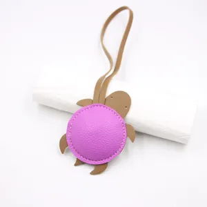 Cute leather turtle bag charm pendant with strap for handbags and decorative accessories.