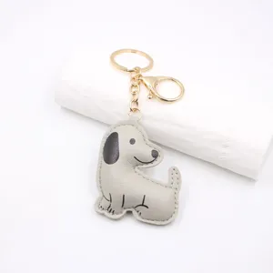 Cute cartoon puppy leather keychain pendant, soft cotton-filled 3D design for bags and car keys.