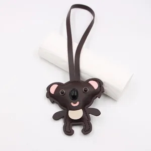 Cute leather koala bag charm detail, cartoon animal backpack pendant accessory.