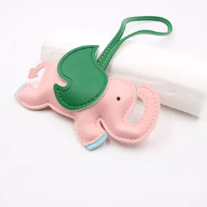 Cute cartoon elephant leather bag charm, stylish pink and green color block pendant.
