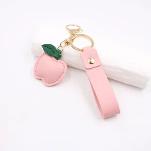 Pink leather peach apple keychain with green leaf, cute metal keyring bag charm pendant accessories.