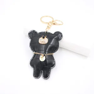 Black crocodile texture leather bear keychain with sparkling rhinestones and gold hardware.