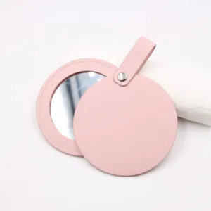 Pink leather round pocket mirror detail, portable makeup mirror bag pendant accessory.