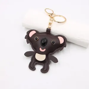 Cute koala leather keychain detail view, cartoon animal bag charm accessory with gold hardware.
