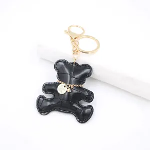 Black leather bear keychain bag charm with gold metal keyring and cute pendant.