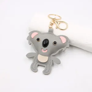 Cute gray leather koala keychain detail, soft texture and sturdy gold metal ring for bags.
