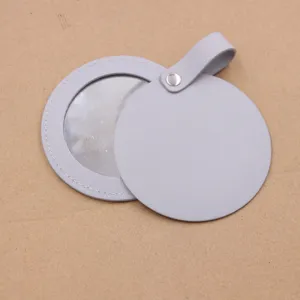 Portable round leather pocket mirror compact cosmetic makeup mirror bag pendant charm accessory.