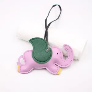 Cute pink elephant leather bag charm with green wings, stylish handbag pendant and denim accessory.