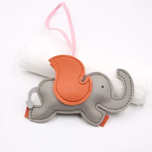 Cute grey leather elephant bag charm with orange wing detail and pink strap accessory.