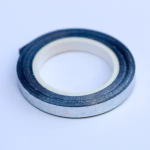 Detail view of the silver holographic balloon ribbon, shiny craft ribbon roll for party decor.